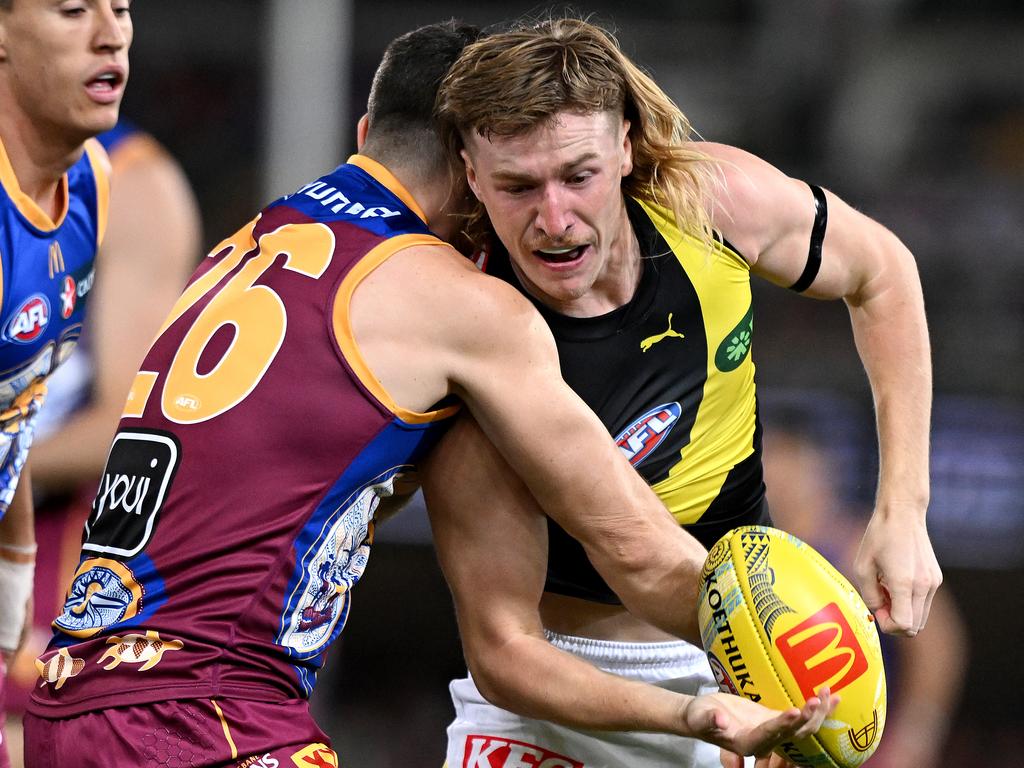 BRISBANE, AUSTRALIA - MAY 18: Hugo Ralphsmith of the Tigers is pressured by the defence during the round 10 AFL match between the Brisbane Lions and Richmond Tigers at The Gabba, on May 18, 2024, in Brisbane, Australia. (Photo by Bradley Kanaris/Getty Images via AFL Photos)