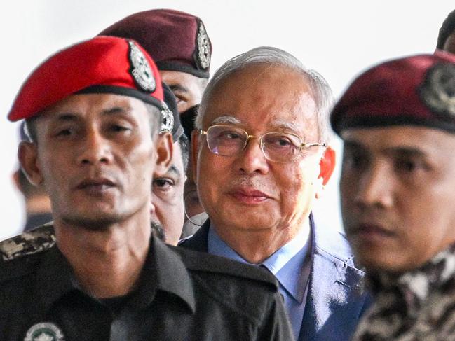 Former Malaysian prime minister Najib Razak (C) arrives at the Kuala Lumpur Court Complex in Kuala Lumpur on October 30, 2024. Najib was sentenced in 2022 to 12 years in jail for offences linked to the misuse of public money in the multi-billion-dollar 1MDB financial scandal. (Photo by Mohd RASFAN / AFP)