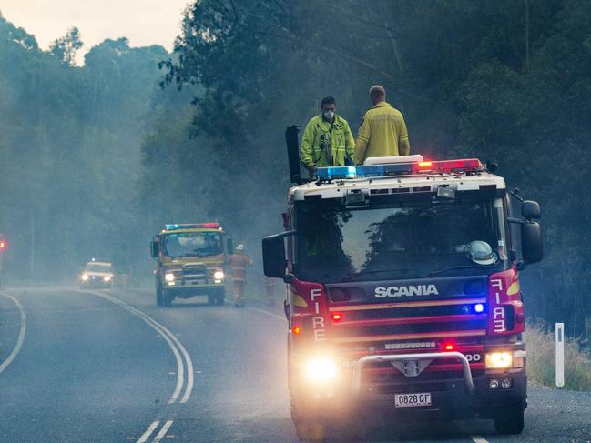 Firefighters on the Doonan Bridge East road where the bushfire started on Wednesday afternoon.  Photo Lachie Millard