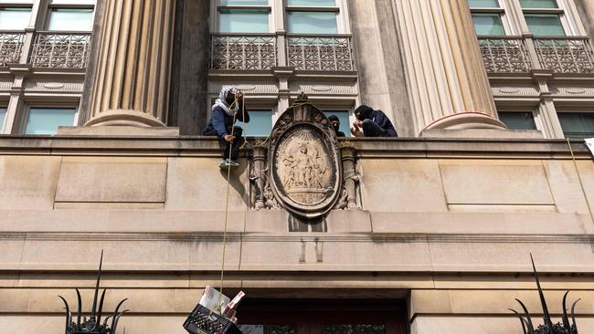 Student protesters pull a crate with pizza boxes inside from a balcony in Hamilton Hall at Columbia University on Tuesday. Picture: AFP