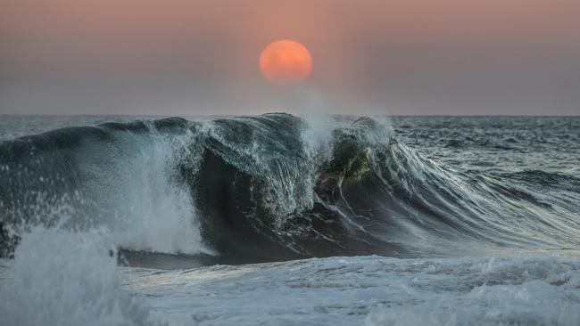 A supermoon rising over the ocean in Australia.