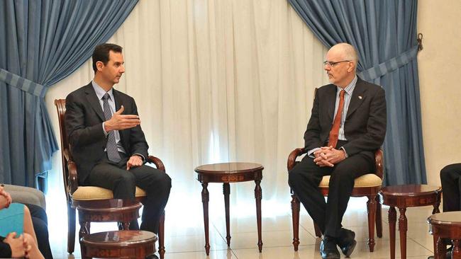 Syrian President Bashar Assad, left, meets with Australian professor Tim Anderson in Damascus, Syria, Monday, Dec. 23, 2013. Picture: Twitter / @Presidency_Sy