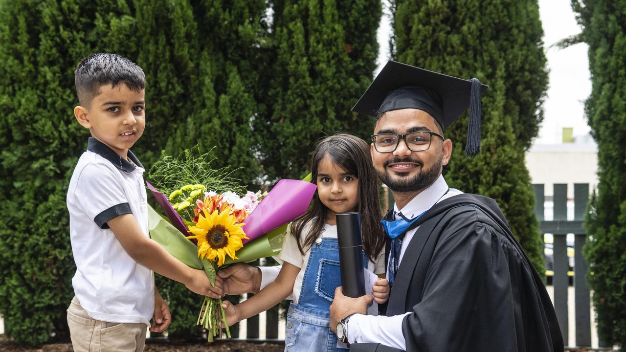 Bachelor of Nursing graduate Harsh is congratulated by nephew Ayaan and niece Alisha Chahal at the UniSQ graduation ceremony at Empire Theatres, Tuesday, December 13, 2022. Picture: Kevin Farmer