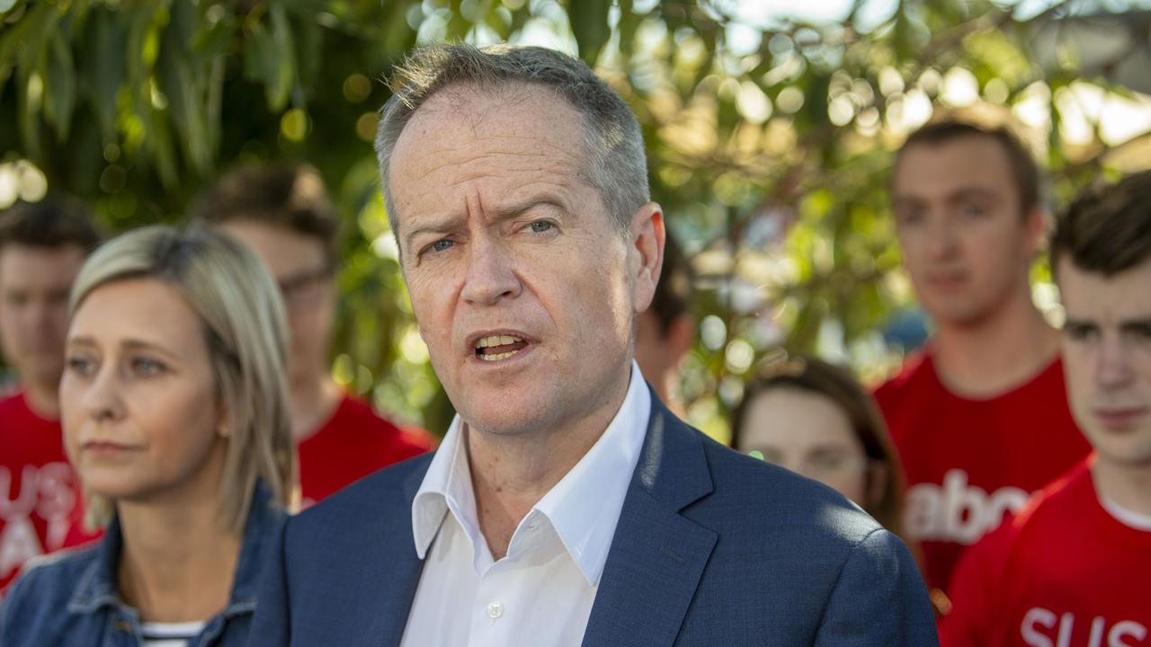 Bill Shorten speaks to the media on Sunday after Susan Lamb, left, won the seat of Longman.