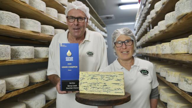 Grand champion: Berrys Creek Cheese owners Barry Charlton and Cheryl Hulls in their cheese storage room with their winning Oak Blue Cheese from this year’s Grand Dairy Awards. Picture: Dannika Bonser