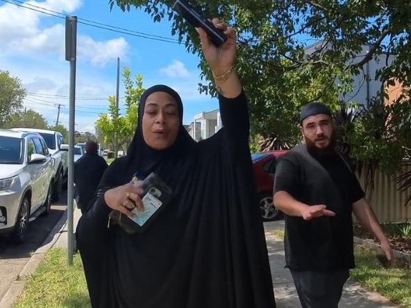 Relatives outside the home of Sarah Abu Lebdeh, the female nurse accused of threatening to kill Israeli patients at Bankstown Hospital.