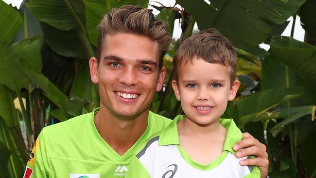 Sydney Thunder cricketer Chris Green with a young fan.