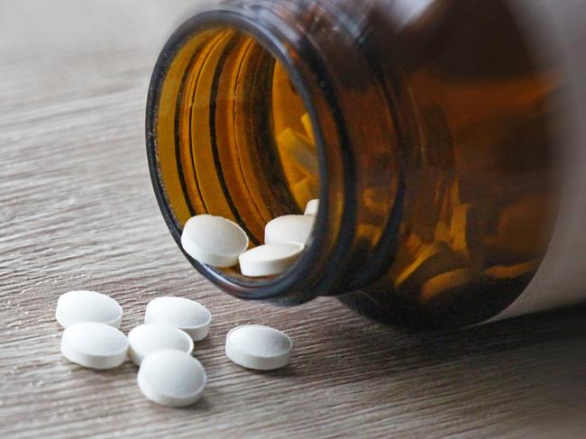 A pill bottle spilling white pills over a counter.Escape 28 January 2024Why I travel Photo - iStock