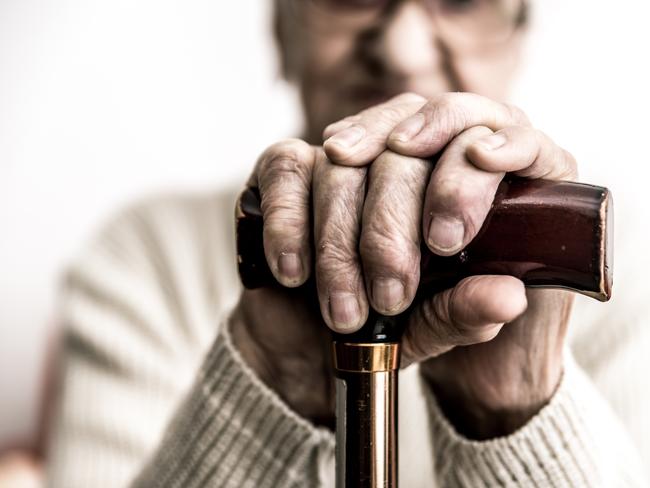 Old woman with cane. Istock