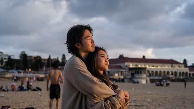 A couple watch the sunrise. Picture: NCA NewsWire / Mario Francisco 