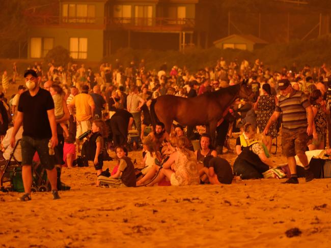 Bushfire arrives into the township of Malua Bay NSW, just south of Batemans Bay. Locals seek refuge on the beach as the fire approaches. Picture: Alex Coppel