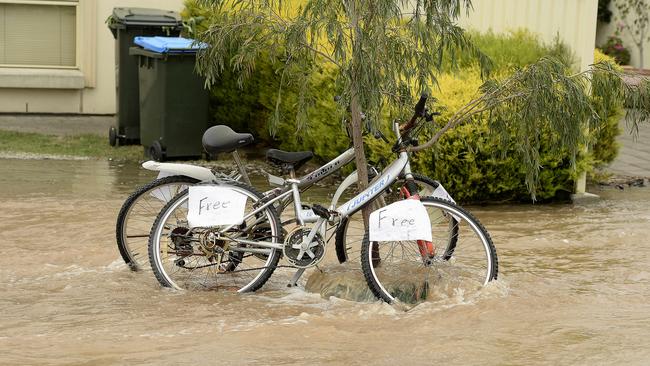 Water floods down Clairville Rd at Campbelltown after the water main burst. Picture: Bianca De Marchi