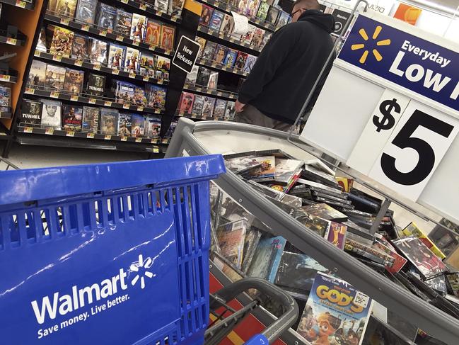 FILE - In this June 5, 2017, file photo, a shopper looks at merchandise at a Walmart in Salem, N.H. Wal-Mart Stores, Inc. reports earnings, Thursday, Aug. 17, 2017. (AP Photo/Elise Amendola, File)