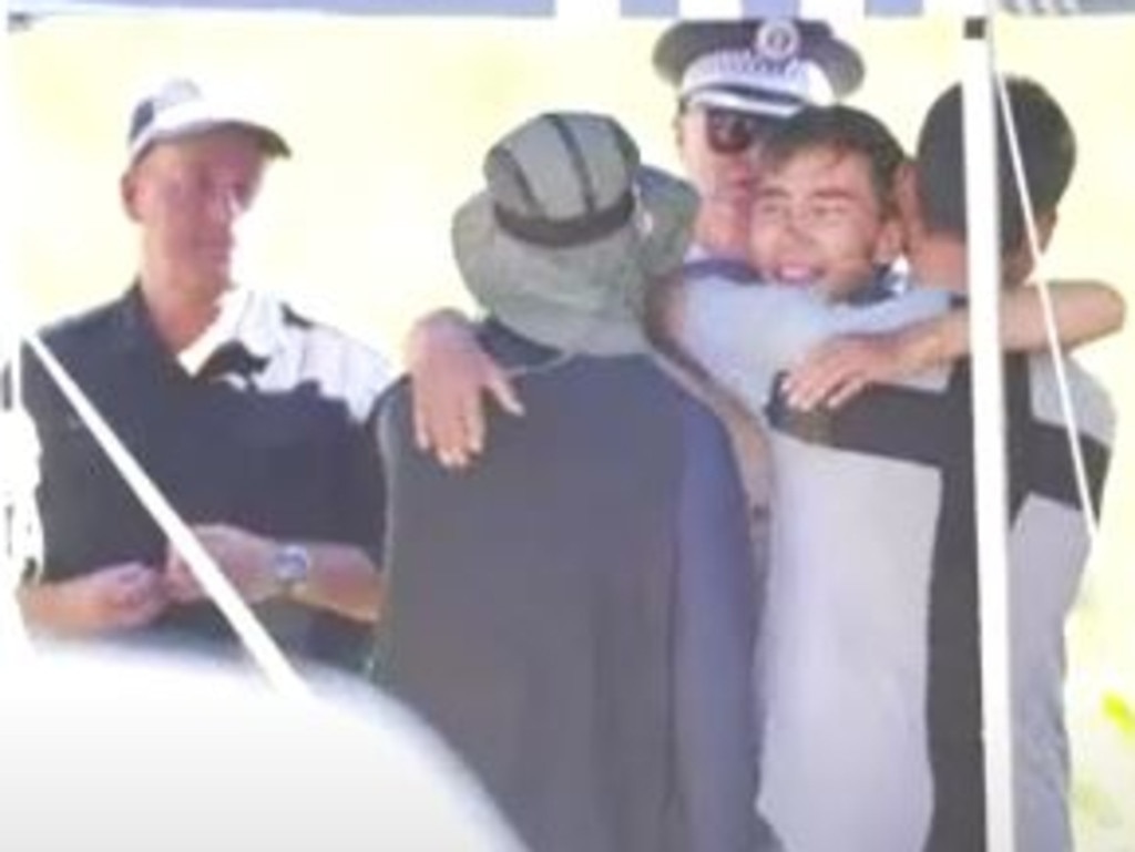 Hadi Nazari, facing the camera, is seen hugging friends after he was found alive. Picture: ABC/Adriane Reardon