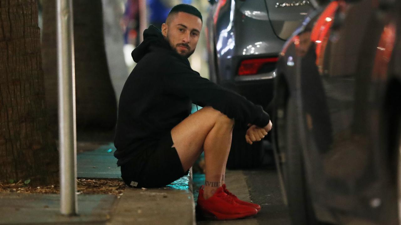 Charles Samuel Percival sits handcuffed on the kerb near Martin Place after being arrested by officers from NSW Police Operation Northrop. Picture: Jonathan Ng