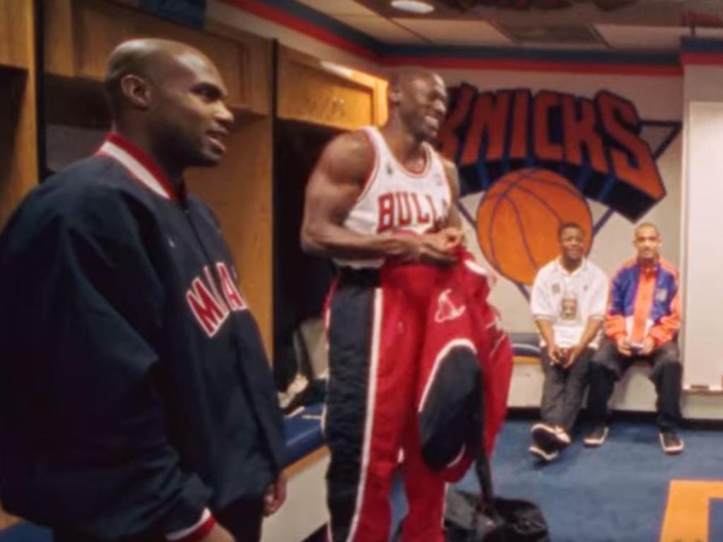 Jordan talks with Tim Hardaway (left) before the game.