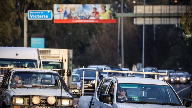 Vehicles sit in a line behind a police checkpoint in Albury today. Picture Getty Images