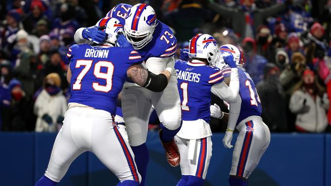 BUFFALO, NEW YORK - JANUARY 15: Spencer Brown #79 and Dion Dawkins #73 of the Buffalo Bills celebrate a touchdown against the New England Patriots during the fourth quarter in the AFC Wild Card playoff game at Highmark Stadium on January 15, 2022 in Buffalo, New York. (Photo by Timothy T Ludwig/Getty Images)