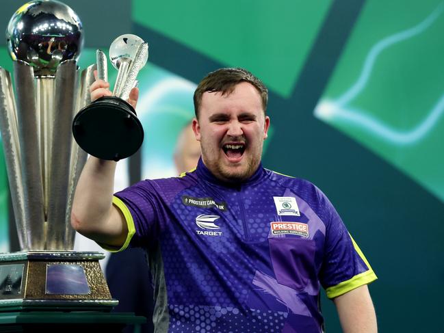 LONDON, ENGLAND - JANUARY 03: Runner-up Luke Littler of England celebrates with the runner-up trophy after the 2023/24 Paddy Power World Darts Championship Final between Luke Littler of England and Luke Humphries of England on Day Sixteen of the 2023/24 Paddy Power World Darts Championship at Alexandra Palace on January 03, 2024 in London, England. (Photo by Tom Dulat/Getty Images)