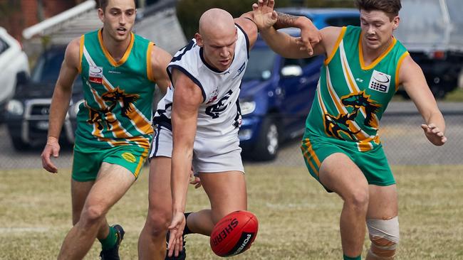 Ben Cardamone fends off two Mustangs. Picture: Greg Hotker