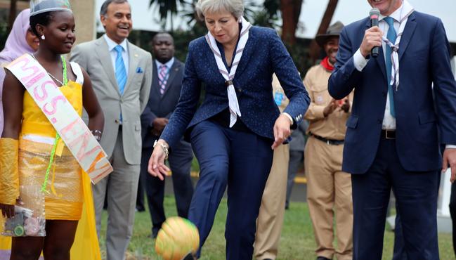 Theresa May kicks a ball made of recycled plastic during her visit to the United Nations complex within Gigiri in Nairobi. Picture: Reuters