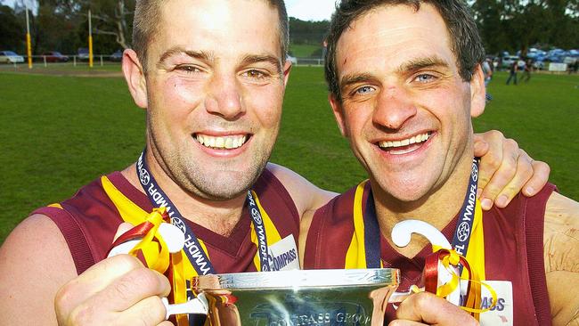 Monbulk captain Vin Dunstan and coach Chris Hughson celebrate with the silverware. Picture: Andy Drewitt