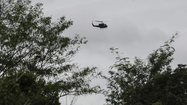 A Thai military helicopter flies over the Tham Luang cave area. Picture: AFP