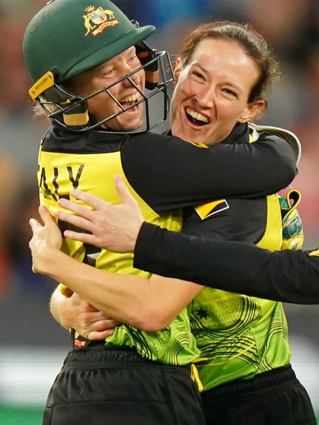 Megan Schutt and Alyssa Healy celebrate a wicket.