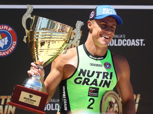Matt Bevilacqua holds the Series trophy after winning during round six of the Nutri-Grain Ironman at Kurrawa Beach on February 05, 2023 in Gold Coast, Australia. (Photo by Chris Hyde/Getty Images)