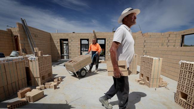 Homegroup tradies John Inwards (closest) and Perry Albon at LendLease's Alkimos Beach subdivision north of Perth. Picture: Colin Murty