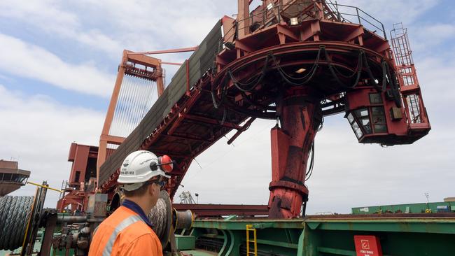 An operations manager watches the ship loader as it loads the Cape Ray with coal at Port Kembla. Picture: Simon Bullard