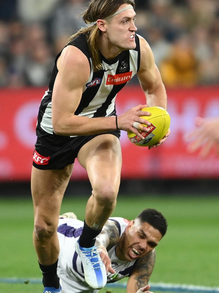 Darcy Moore avoids a tackle from Michael Walters. Picture: Getty Images