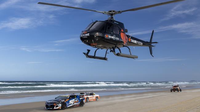 Supercars driver Cameron Hill, the Boost drift car, Buggy, Chopper, and Stunt plain as they raced along Main Beach today ahead of this weekend’s Boost Mobile GC 500, Event 11 of the Repco Supercars Championship, Surfers Paradise, Gold Coast, Queensland, Australia.