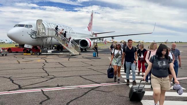 Passengers disembark at Alice Springs airport on Wednesday as the town grapples with an ongoing crime wave.