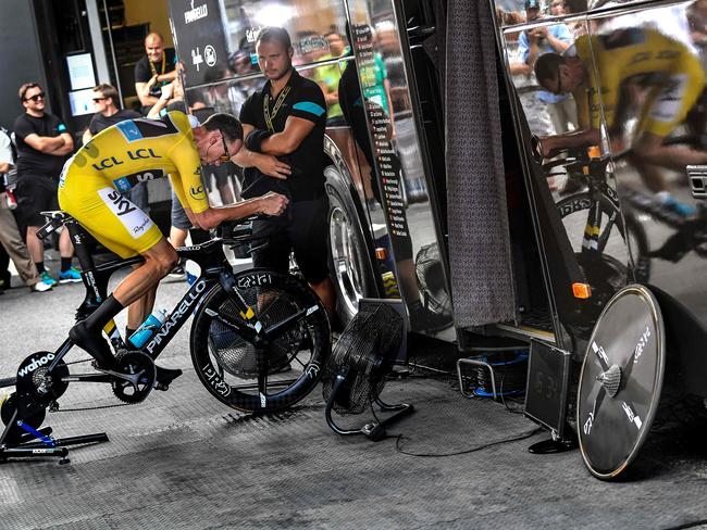 Great Britain's Christopher Froome, wearing the overall leader's yellow jersey, trains prior to the start of the 17km individual time-trial.