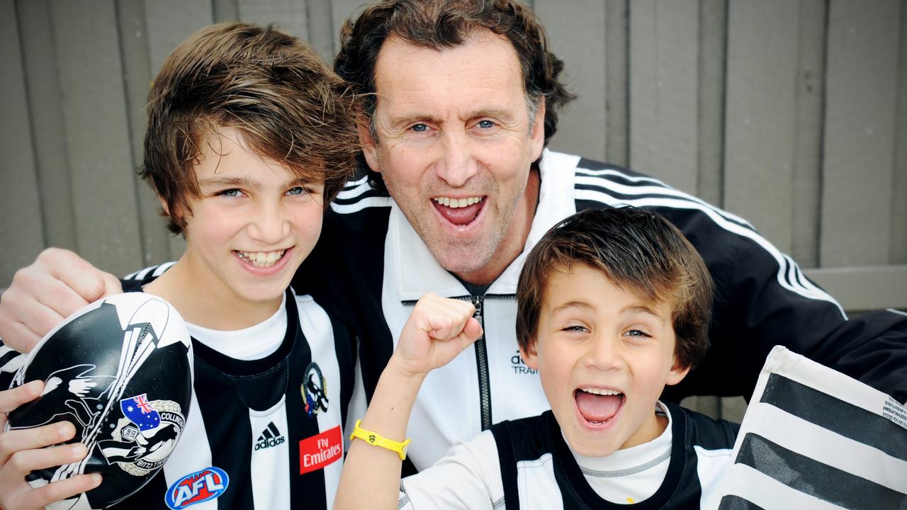 Peter Daicos with Josh aged 11, and Nick aged 7, cheering for Collingwood after a win over Geelong.