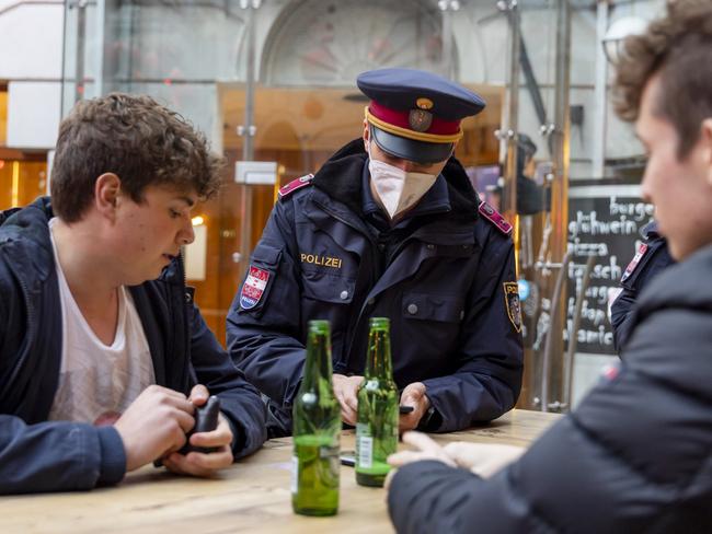 Police officers monitor compliance with the lockdown in Innsbruck's old town during the first day of a nationwide lockdown for people not yet vaccinated against Covid. Picture: Getty Images