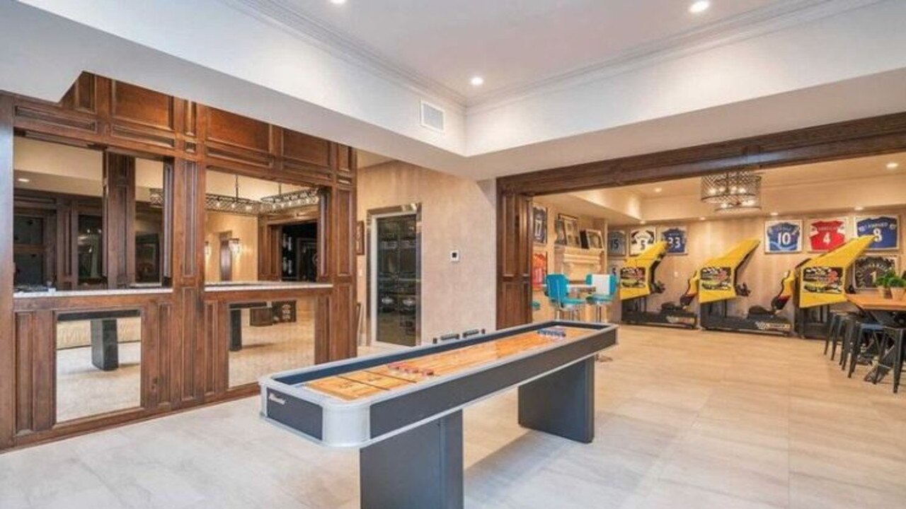 An epic games room has some recognisable guernseys on the walls. Source: realtor.com