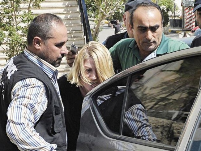 Lebanese policemen escort Tara Brown after she was taken from a Lebanese courthouse to Baabda Prison for women, east of Beirut. Picture: EPA/WAEL HAMZEH