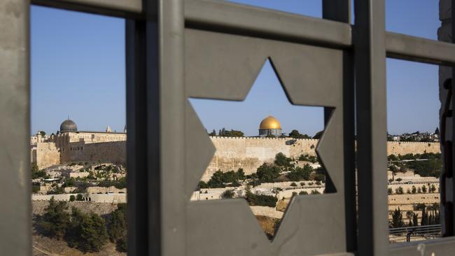The Islamic Dome of the Rock in Jerusalem's Old City is seen trough a door decorated with a Jewish Star of David.