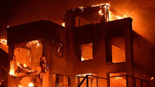 A house is engulfed in flames as the Palisades Fire burns along Pacific Coast Highway in Malibu, California, on January 8, 2025. At least five people have been killed in wildfires rampaging around Los Angeles, officials said on January 8, with firefighters overwhelmed by the speed and ferocity of multiple blazes -- including in Hollywood. (Photo by AGUSTIN PAULLIER / AFP)