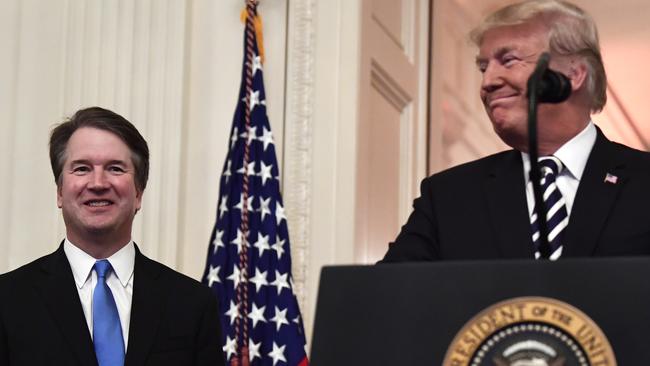 President Donald Trump, right, smiles as he stands with Supreme Court Justice Brett Kavanaugh. Picture: AFP