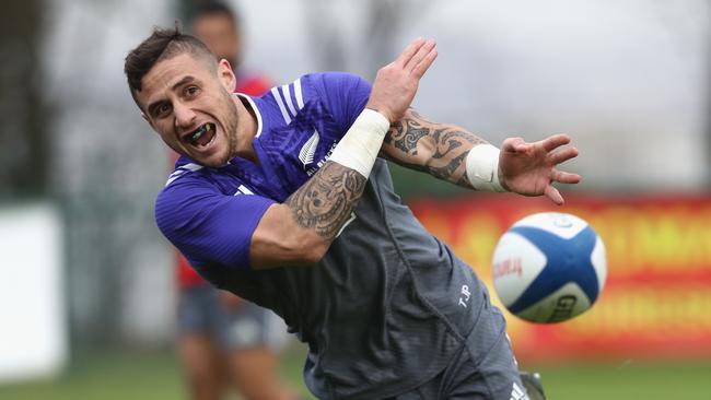 TJ Perenara of the All Blacks passes during training at the Suresnes Rugby Club.