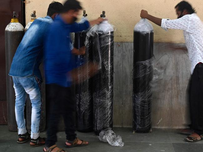 Staff unwrap oxygen cylinders at a newly set up COVID care centre in Mumbai. Picture: AFP