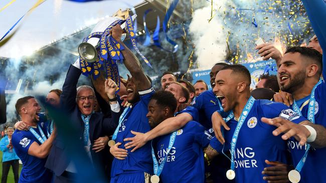 Captain Wes Morgan and manager Claudio Ranieri of Leicester City lift the Premier League Trophy.