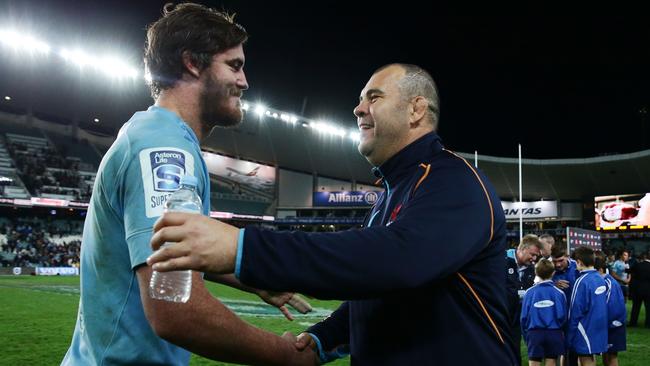 Waratahs coach Michael Cheika celebrates with Kane Douglas.