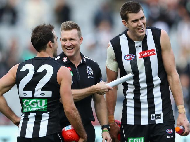 MELBOURNE, AUSTRALIA - MAY 21:  Steele Sidebottom, Nathan Buckley and Mason Cox of the Magpies have a laugh after winning the round nine AFL match between the Collingwood Magpies and the Carlton Blues at Melbourne Cricket Ground on May 21, 2016 in Melbourne, Australia.  (Photo by Quinn Rooney/Getty Images)