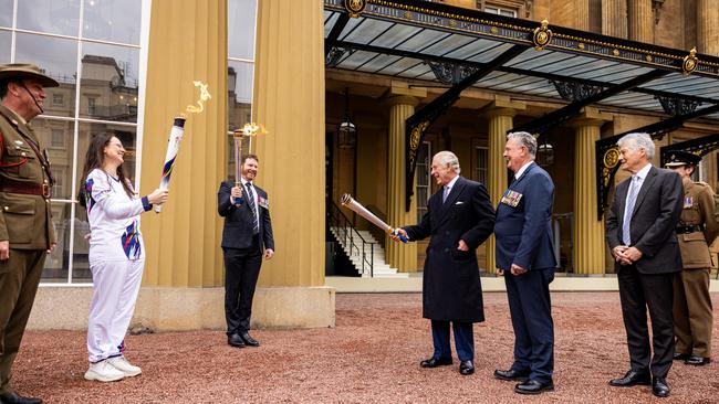 King Charles at Buckingham Palace with Dan Keighran, Angela Brient and the Legacy torch. Pic: Callum Smith