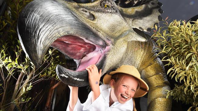 Bridie McCauley gets up close to a dinosaur at Dinosaur World. Picture: Rob Leeson