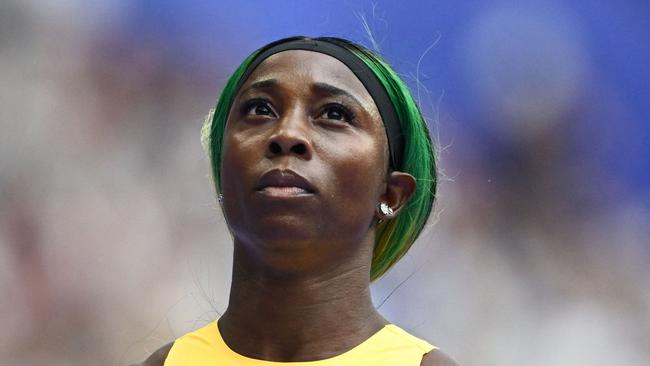 Jamaica's Shelly-Ann Fraser-Pryce reacts after competing in the women's 100m heat of the athletics event at the Paris 2024 Olympic Games at Stade de France in Saint-Denis, north of Paris, on August 2, 2024. (Photo by Jewel SAMAD / AFP)